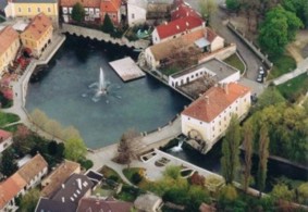 A nice inner pond with a traditional mill and a cave